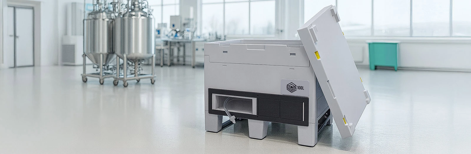 BagBox-cleanroom-transport-container-with-open-lid-positioned-inside-a-GMP-compliant-bioprocessing-suite-with-stainless-steel-vessels.jpg