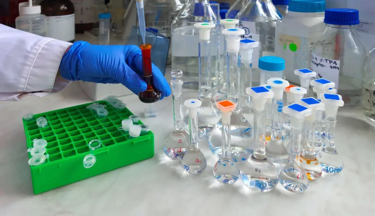 A lab technician working with vials of bio fluids.
